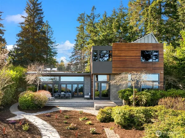a front view of a house with a garden