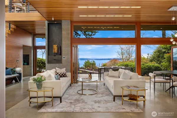 a living room with furniture and a floor to ceiling window