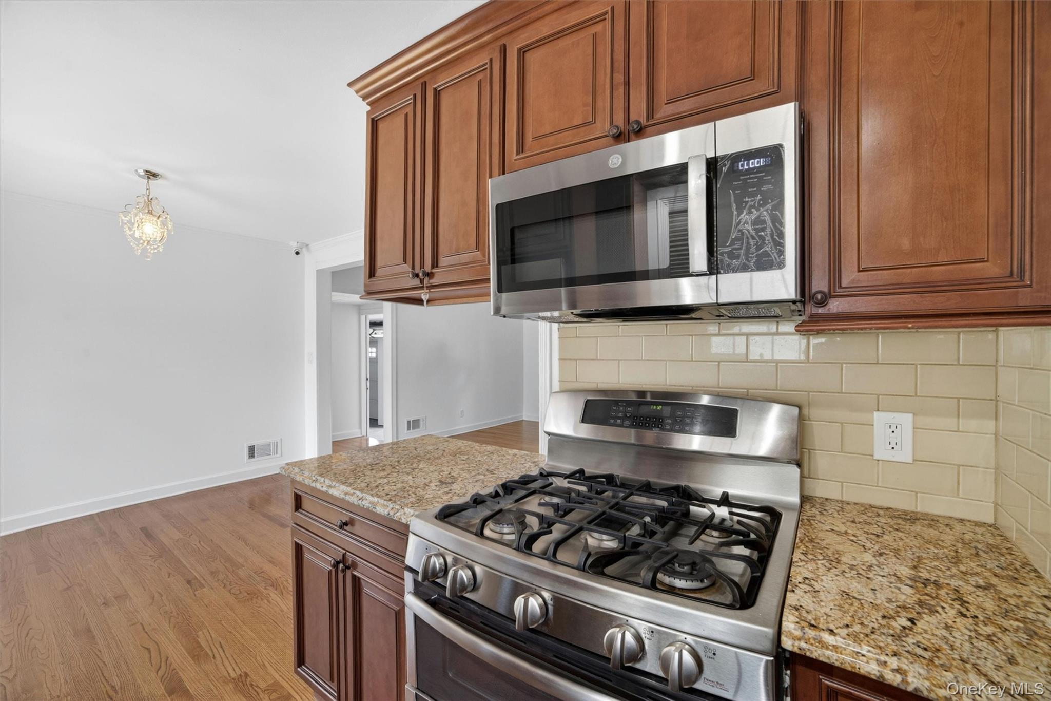 263 Croydon Road Yonkers, NY 10710 - Photo 12 of 43 a kitchen with granite countertop a stove and a microwave