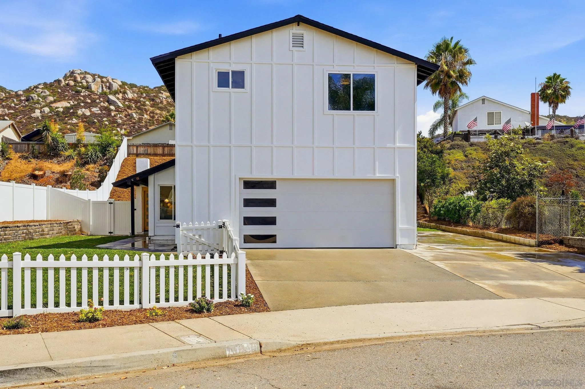 10440 Bosque Drive Lakeside, CA 92040 - Photo 2 of 47 a front view of a house with a garden