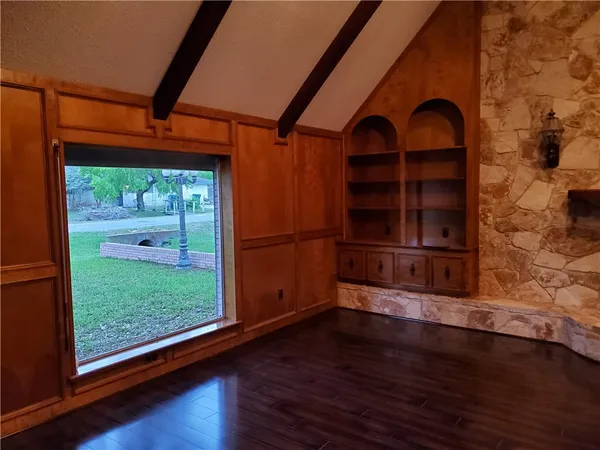 a view of room with wooden floor and window