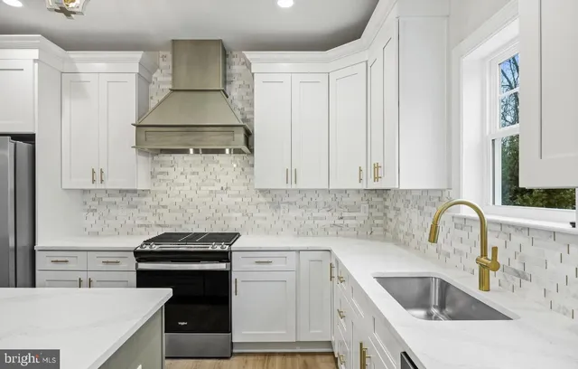 a kitchen with a sink stove and refrigerator
