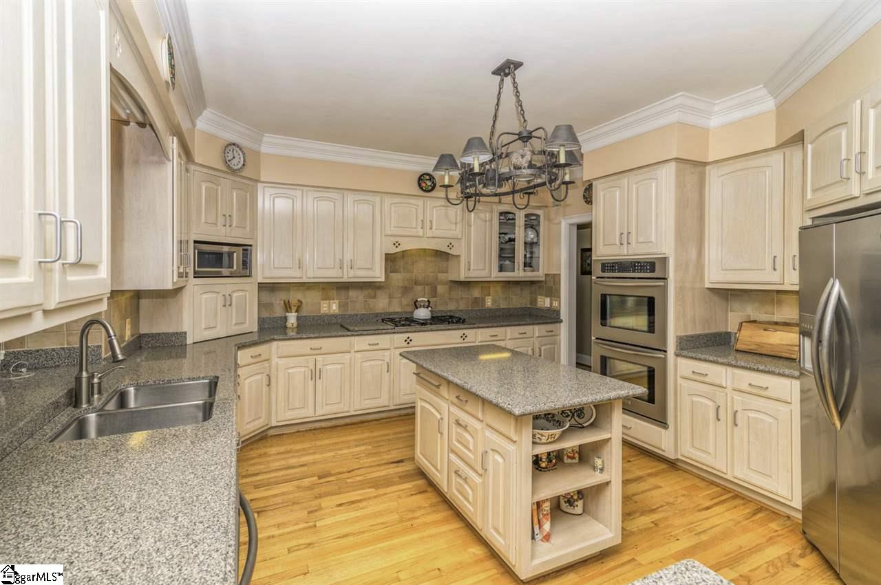 220 Block House Road Greenville, SC 29615 - Photo 10 of 36 Kitchen with Beautiful Custom Cabinets, Tiled Backsplash, Silestone Countertops, and Plant Shelf at Kitchen Window