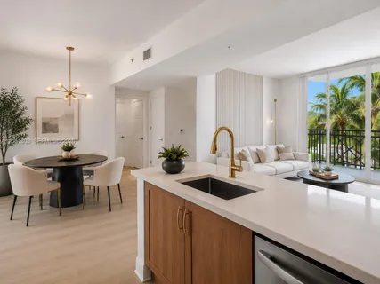 a kitchen with a sink a counter and chairs
