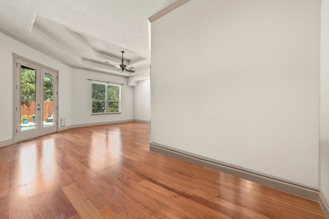 139 Ware Drive Buda, TX 78610 - Photo 26 of 40 an empty room with wooden floor and windows