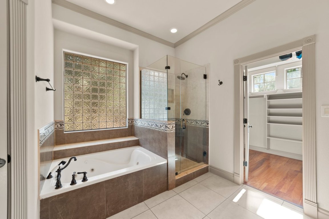 139 Ware Drive Buda, TX 78610 - Photo 29 of 40 a bathroom with a bathtub and a shower