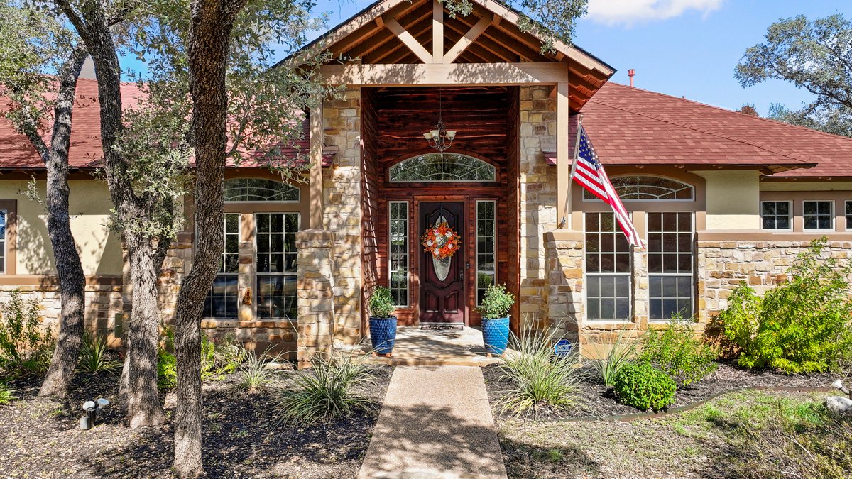 139 Ware Drive Buda, TX 78610 - Photo 5 of 40 a front view of a house with glass windows and plants
