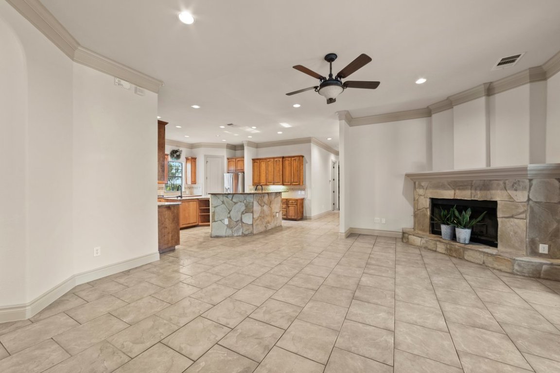 139 Ware Drive Buda, TX 78610 - Photo 9 of 40 a view of a livingroom with a fireplace a sink and a kitchen space