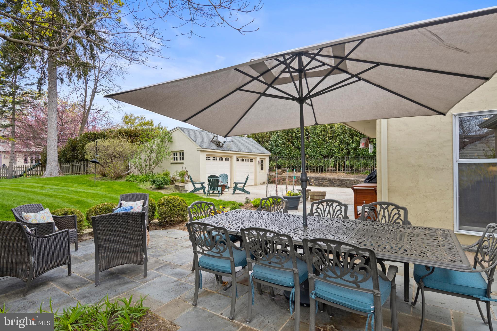 421 St Davids Road Wayne, PA 19087 - Photo 33 of 39 a view of a patio with a table and chairs under an umbrella