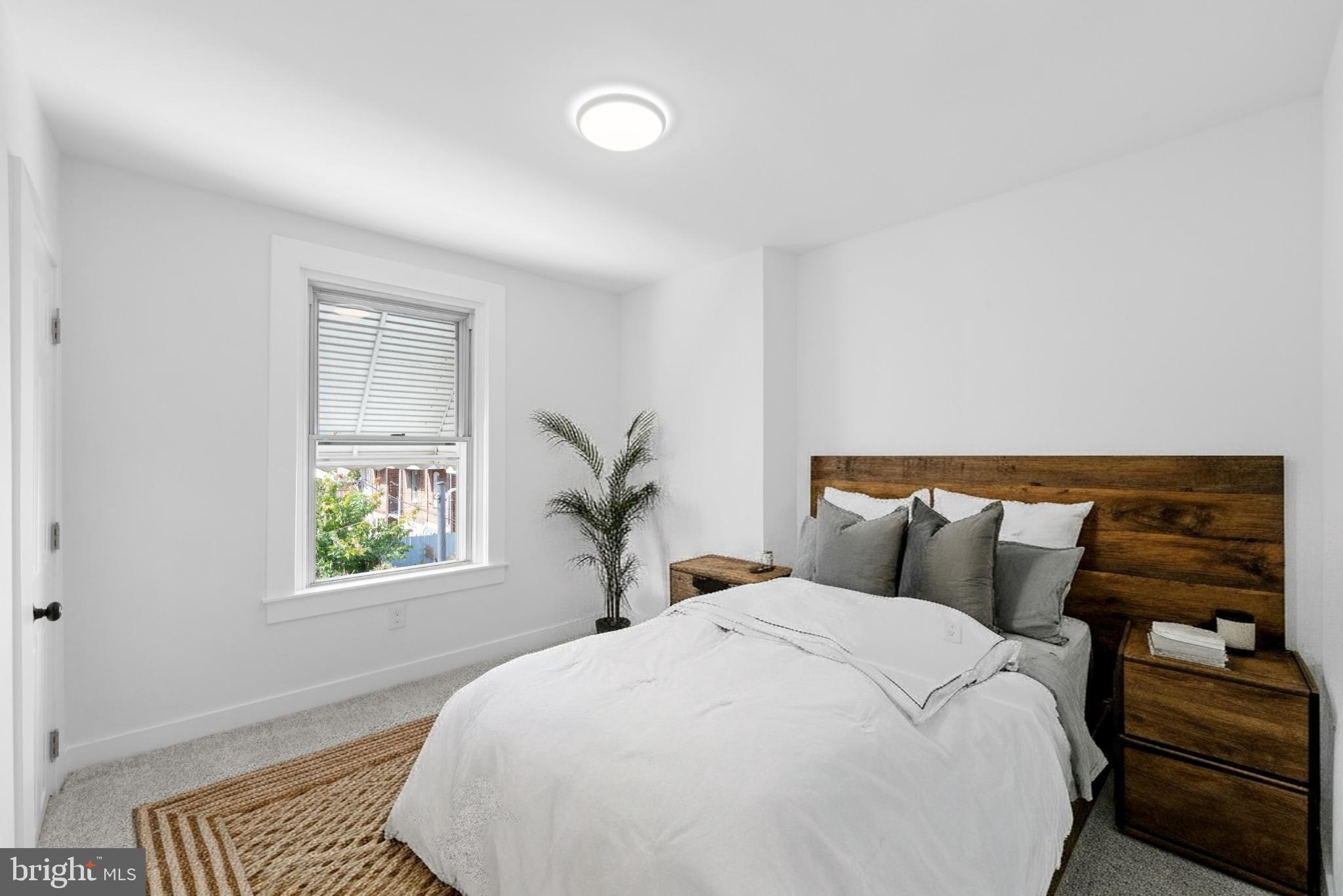 2508 East Indiana Avenue Philadelphia, PA 19134 - Photo 16 of 37 a bed sitting in a bedroom next to a window