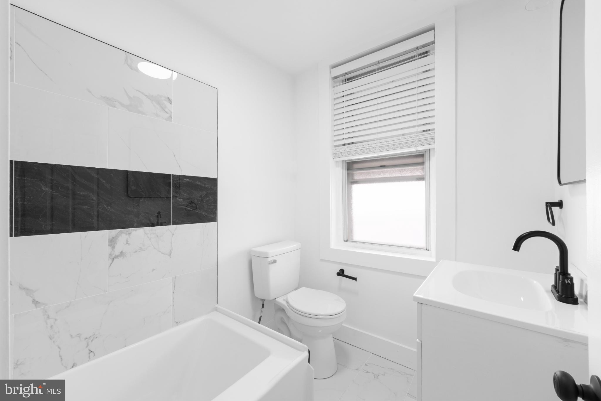 2508 East Indiana Avenue Philadelphia, PA 19134 - Photo 18 of 37 a bathroom with a sink a toilet and shower