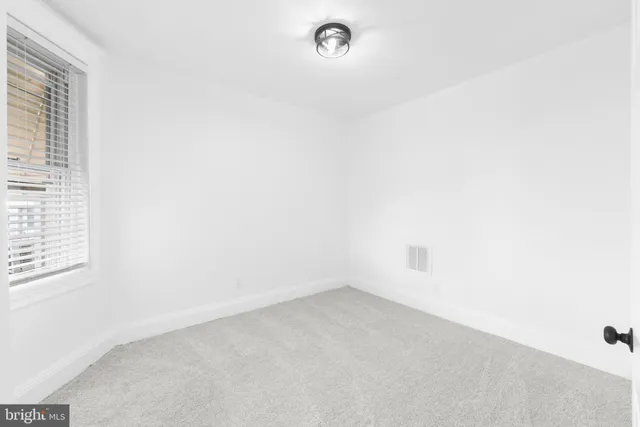 a view of an empty room with windows