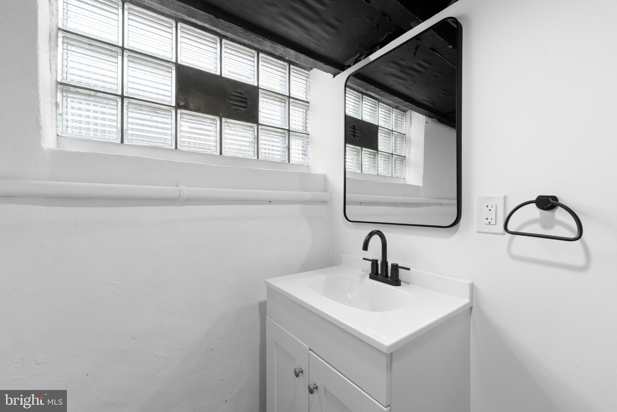 2508 East Indiana Avenue Philadelphia, PA 19134 - Photo 29 of 37 a bathroom with a sink and a mirror