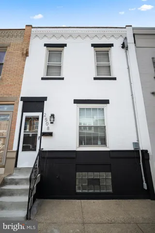 an empty room with windows cabinet and fireplace