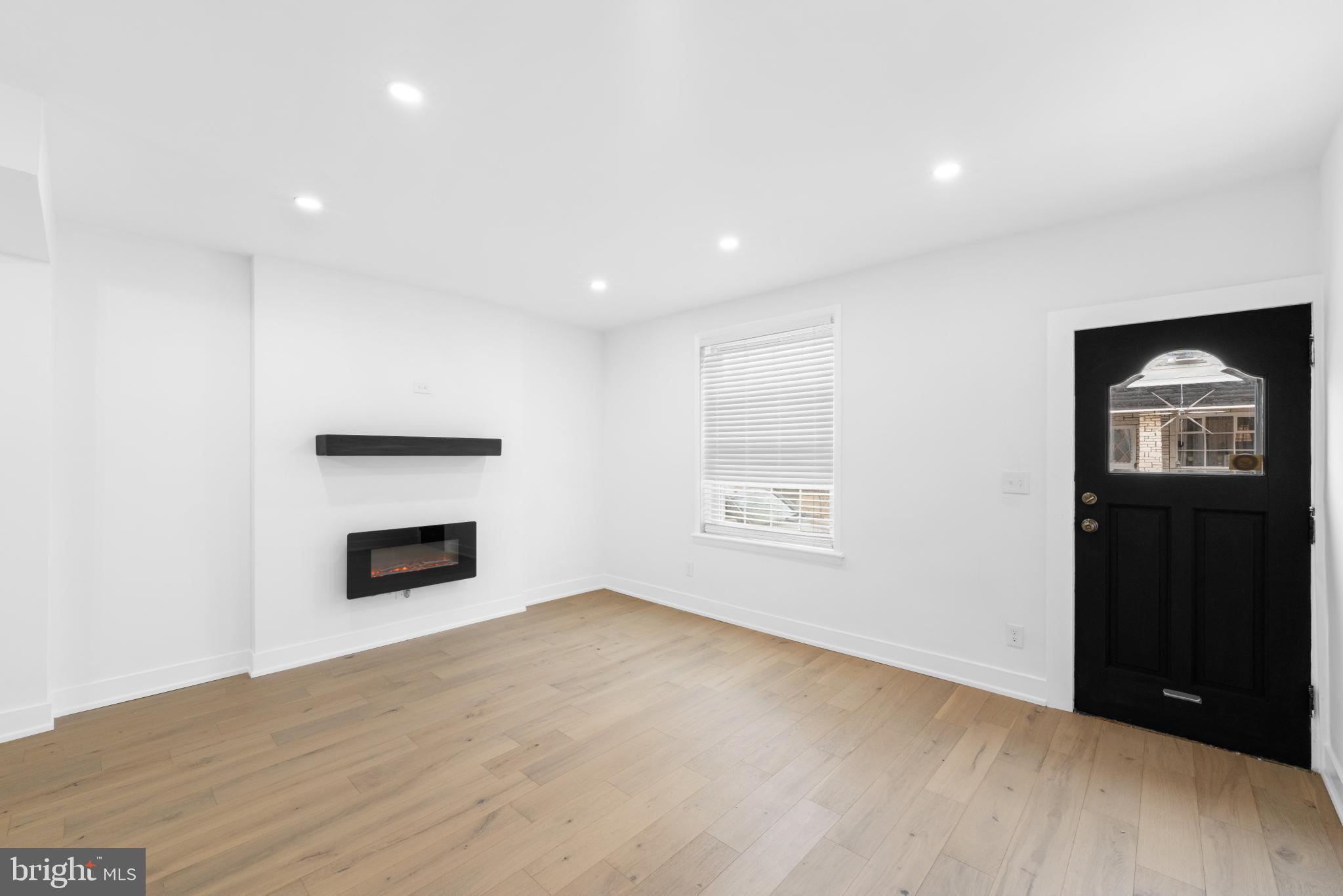 2508 East Indiana Avenue Philadelphia, PA 19134 - Photo 5 of 37 an empty room with windows cabinet and fireplace