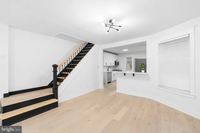 a kitchen with a refrigerator sink stove and cabinets