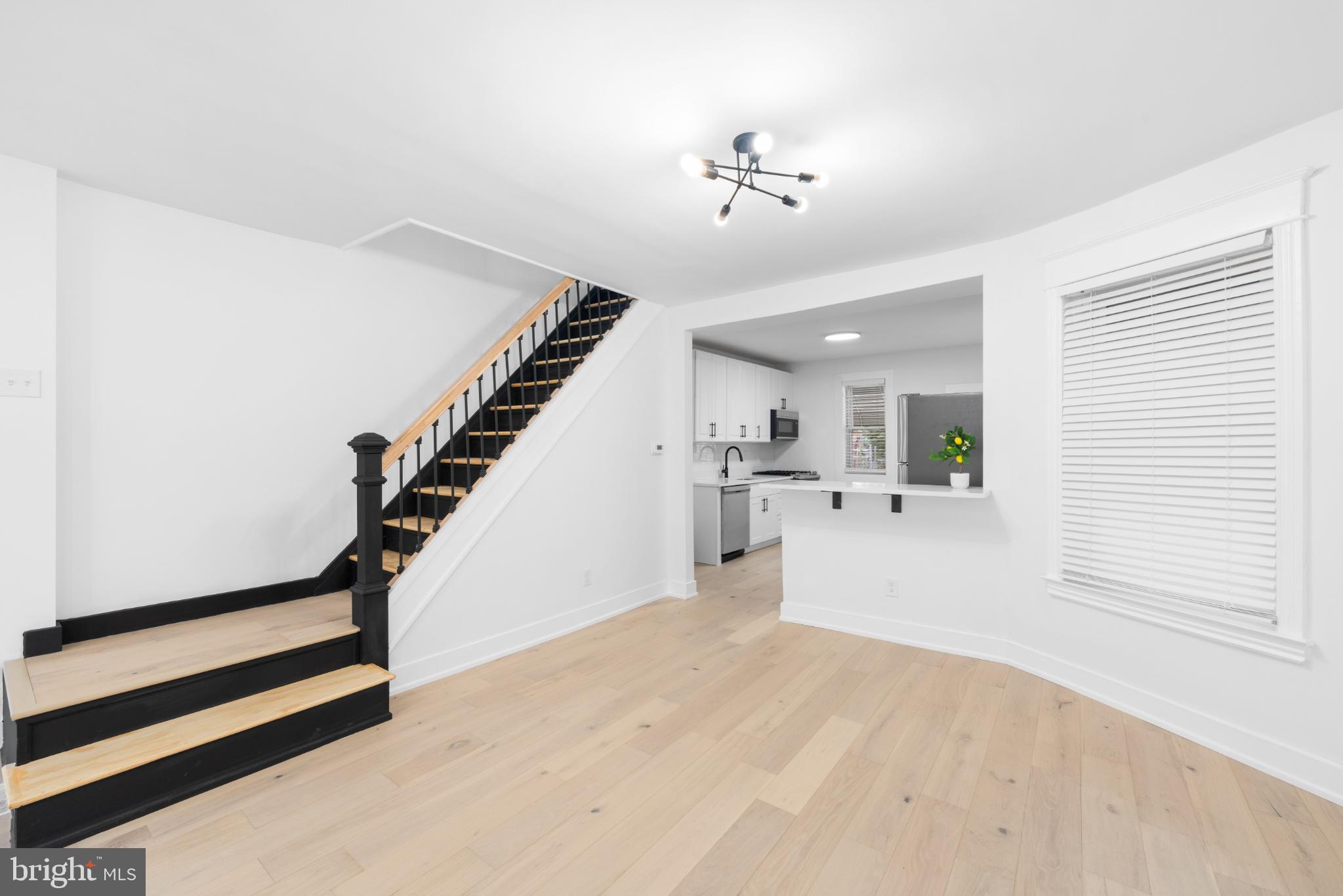 2508 East Indiana Avenue Philadelphia, PA 19134 - Photo 8 of 37 a view of a hallway with wooden floor and staircase