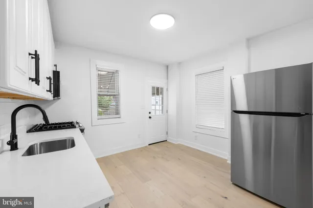 a kitchen with granite countertop a stove and a sink