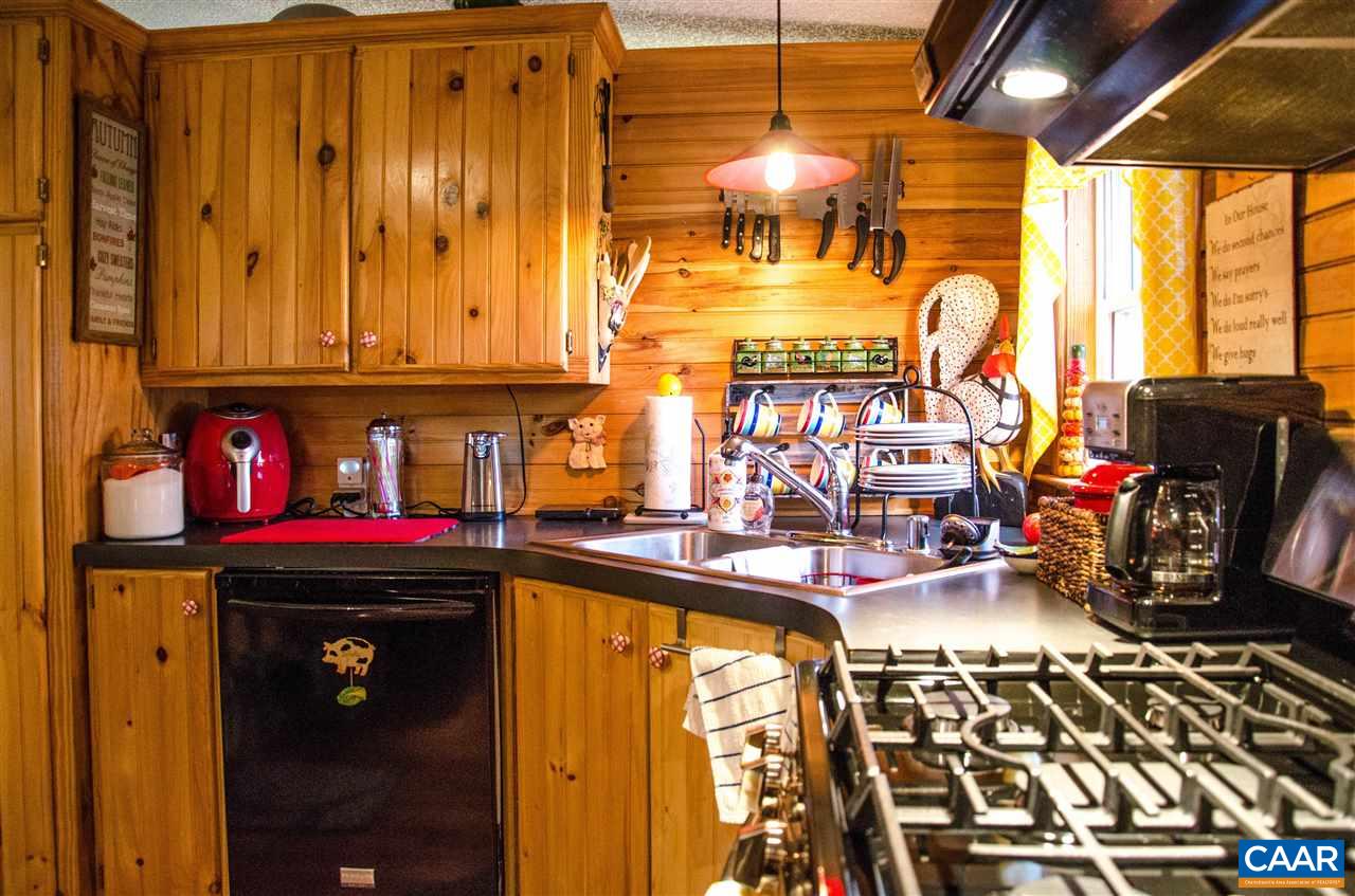 3919 Firehouse Road Howardsville, VA 24562 - Photo 13 of 49 a kitchen with a stove and a refrigerator