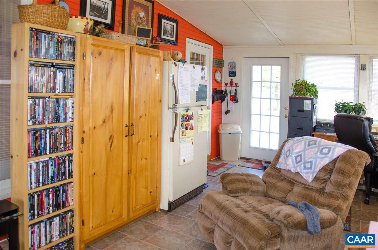 3919 Firehouse Road Howardsville, VA 24562 - Photo 21 of 49 a living room with furniture a bookshelf and a window