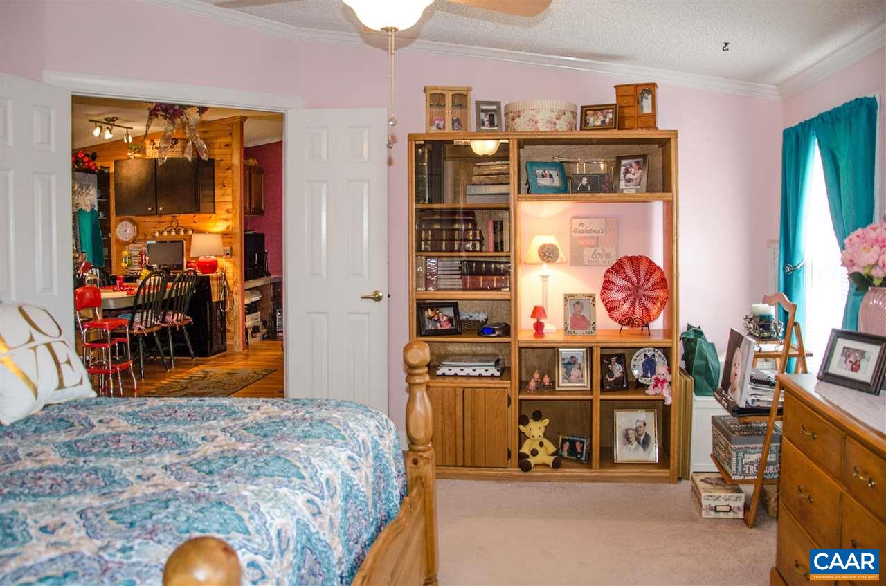 3919 Firehouse Road Howardsville, VA 24562 - Photo 24 of 49 a bed room with a bed and a television