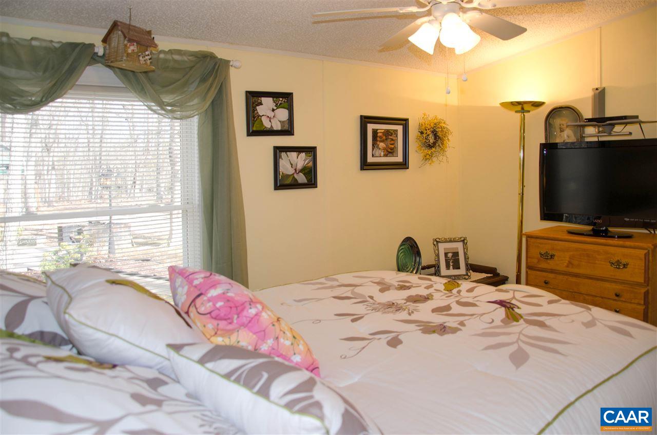 3919 Firehouse Road Howardsville, VA 24562 - Photo 35 of 49 a bedroom with a bed and a flat screen tv