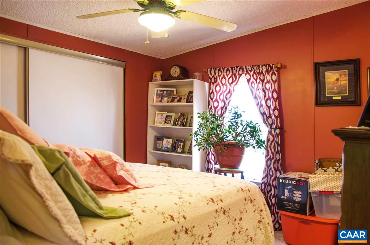 3919 Firehouse Road Howardsville, VA 24562 - Photo 37 of 49 a bedroom with a bed and a chair