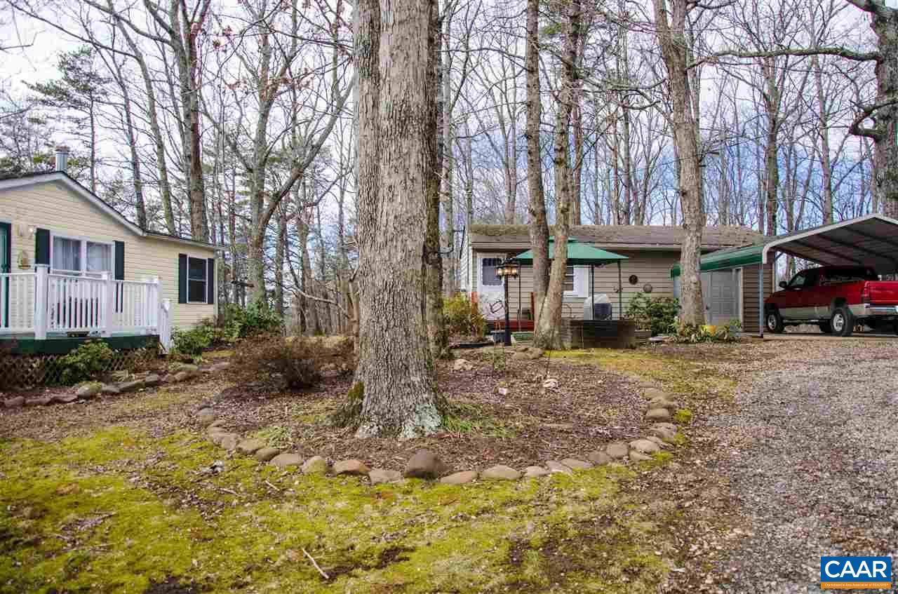 3919 Firehouse Road Howardsville, VA 24562 - Photo 48 of 49 a view of a house with a yard covered in the forest