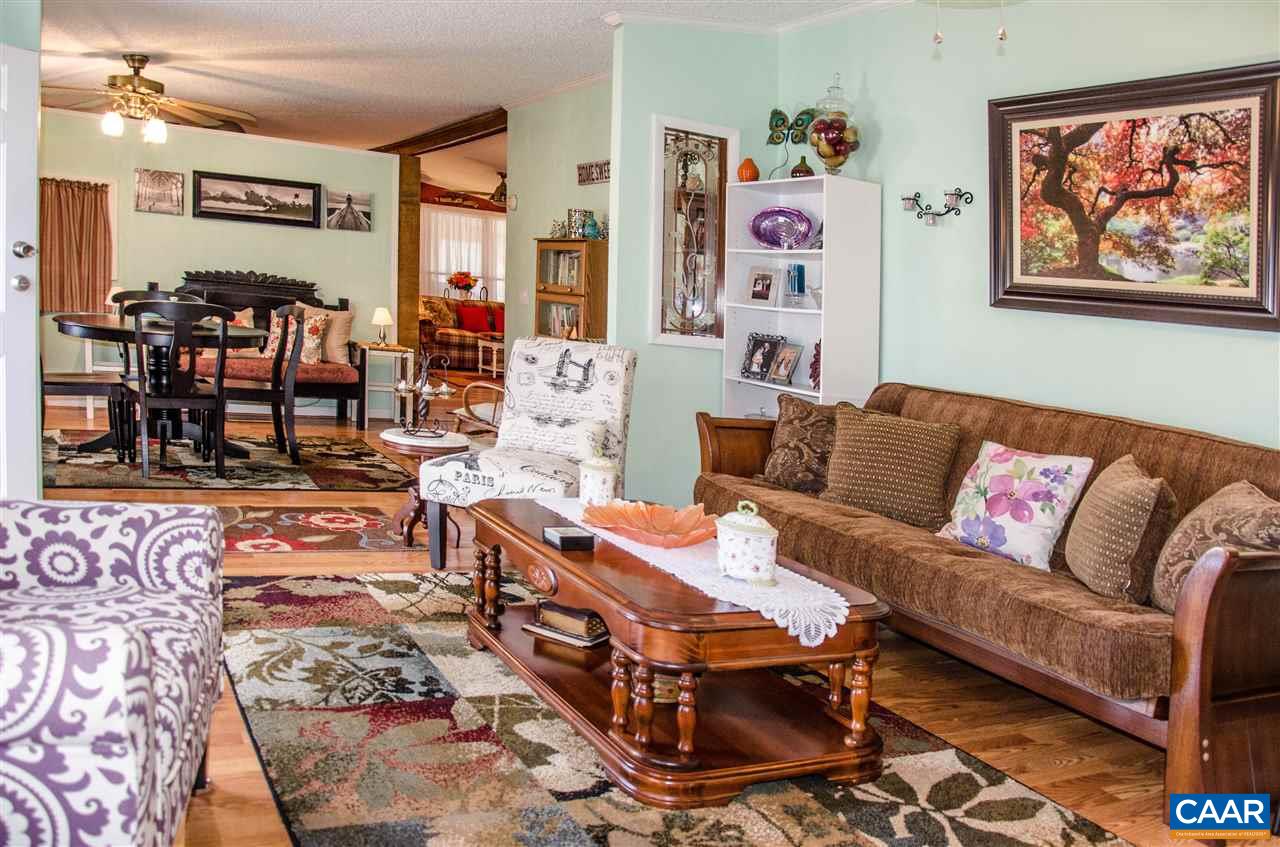 3919 Firehouse Road Howardsville, VA 24562 - Photo 9 of 49 a living room with furniture and painting on the wall