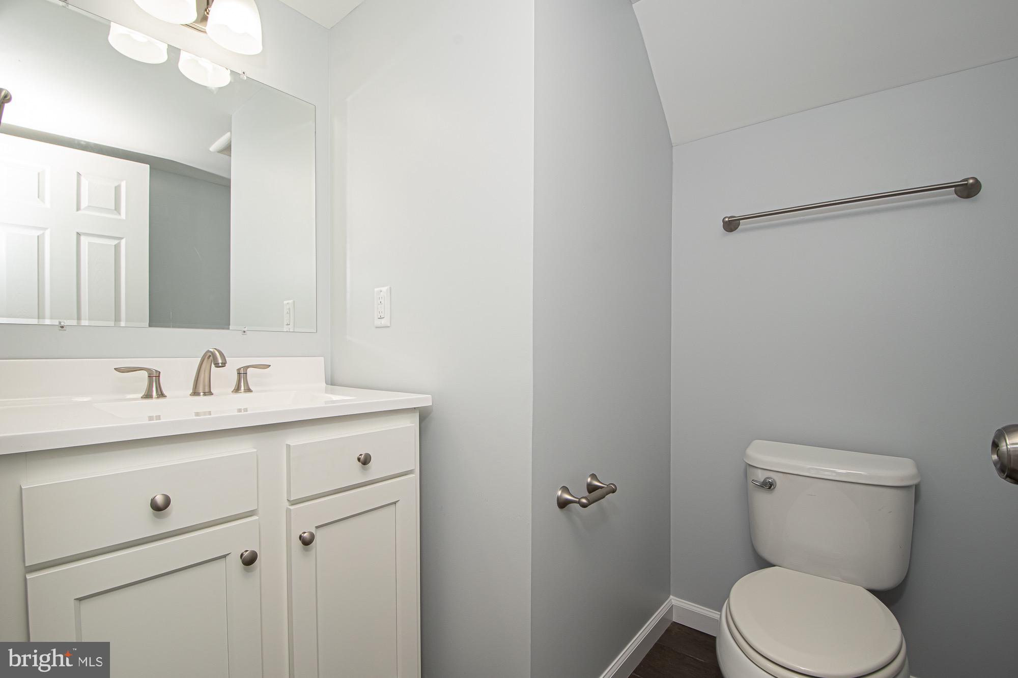 709 Ross Street Winchester, VA 22601 - Photo 31 of 40 a bathroom with a granite countertop toilet sink and mirror