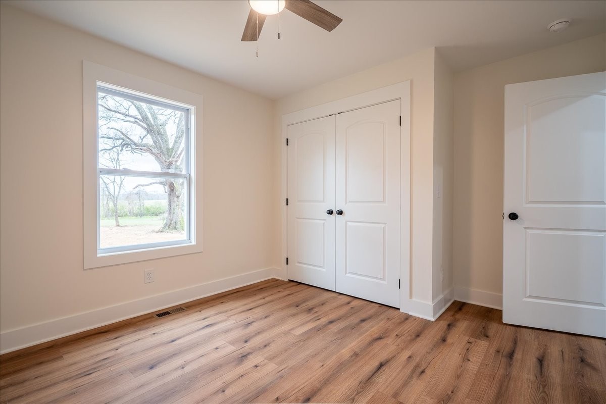 3987 Buffalo Road Summertown, TN 38483 - Photo 16 of 26 a view of an empty room with wooden floor and a window