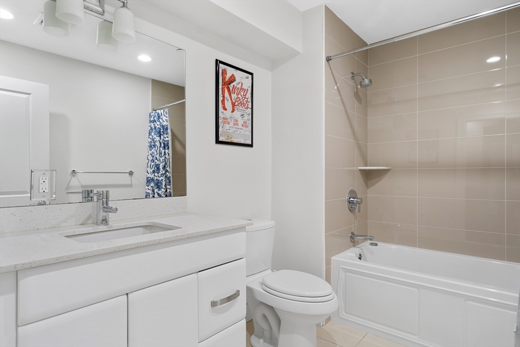 1471 Beacon Street, Unit 1 Brookline, MA 02446 - Photo 15 of 20 a bathroom with a sink a toilet and a bathtub
