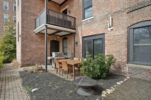 a view of a patio with table and chairs and potted plants