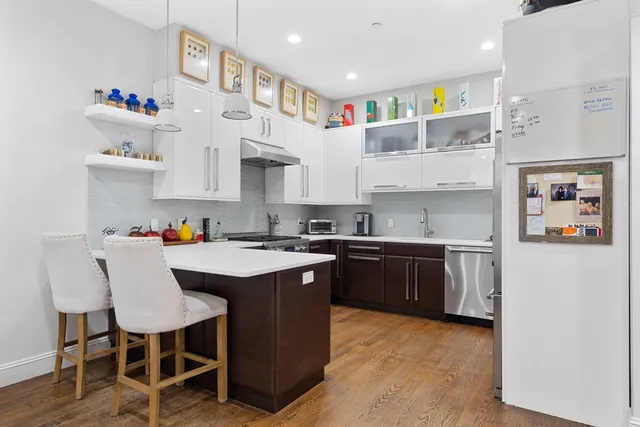 a kitchen with cabinets a sink and appliances