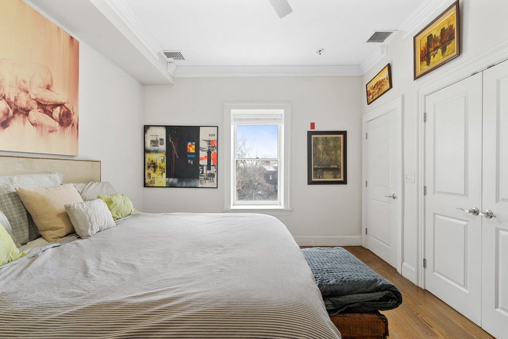 1471 Beacon Street, Unit 1 Brookline, MA 02446 - Photo 9 of 20 a bedroom with a large bed and a window