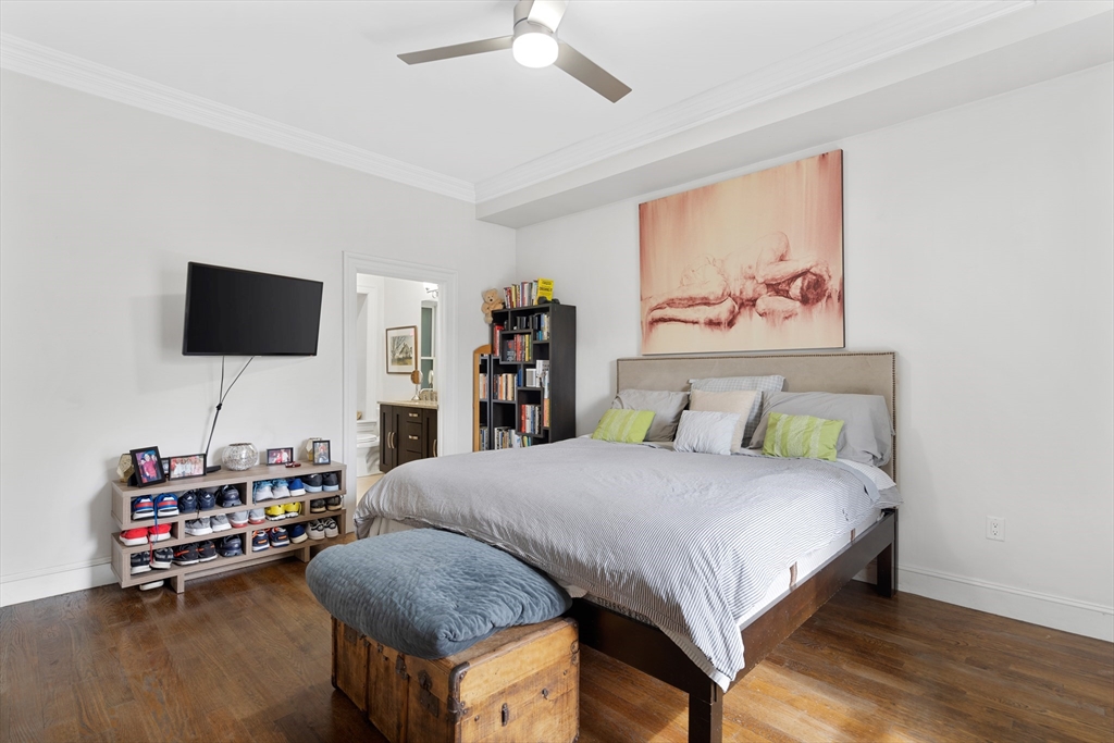 1471 Beacon Street, Unit 1 Brookline, MA 02446 - Photo 10 of 20 a bedroom with a bed furniture and a flat screen tv