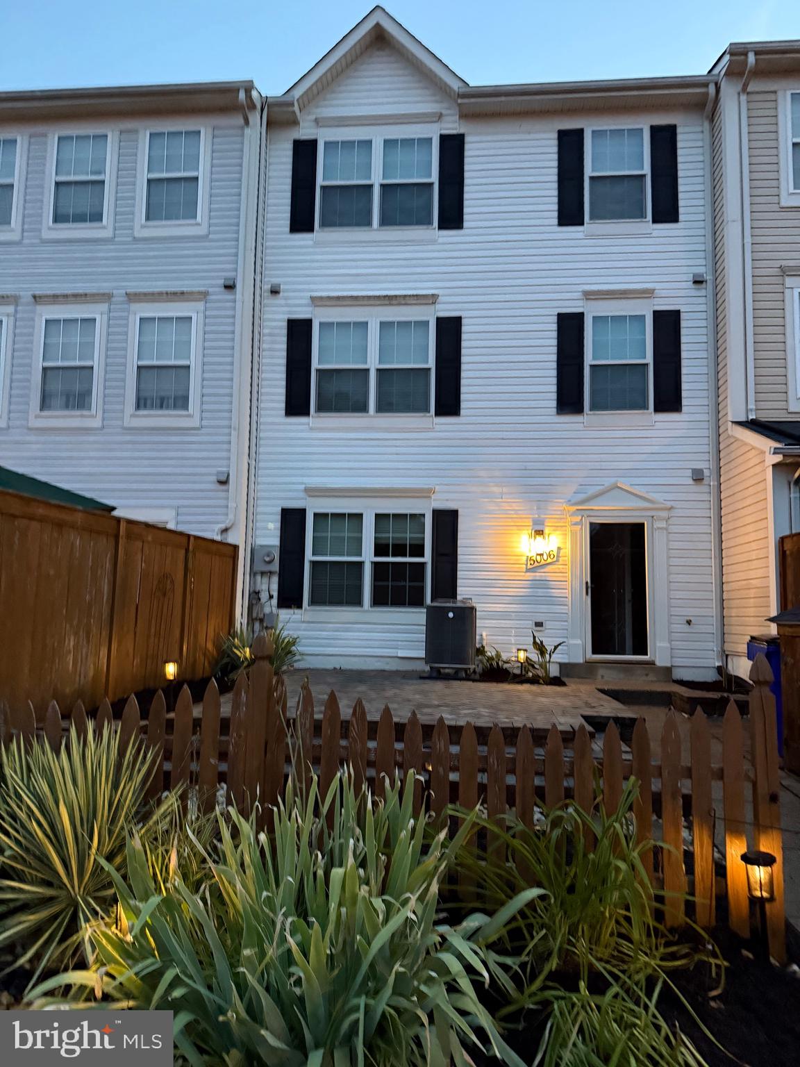 5006 Croydon Terrace Frederick, MD 21703 - Photo 20 of 20 a view of a brick house with many windows and potted plants