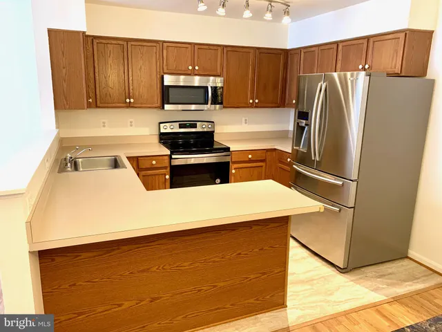 a kitchen with a refrigerator sink and microwave