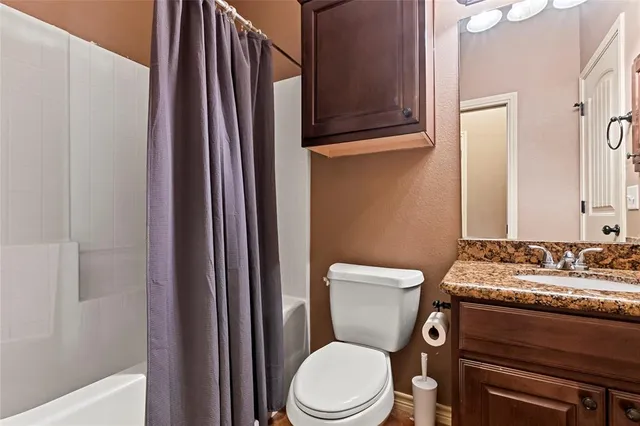 a white toilet sitting next to a bathroom sink
