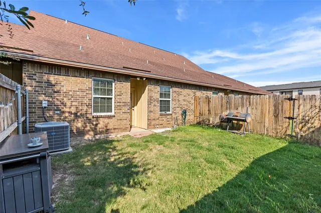 a backyard of a house with table and chairs