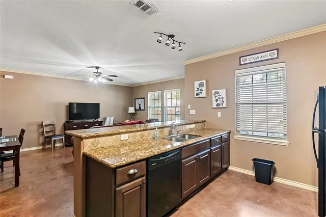 a living room with granite countertop furniture and a flat screen tv