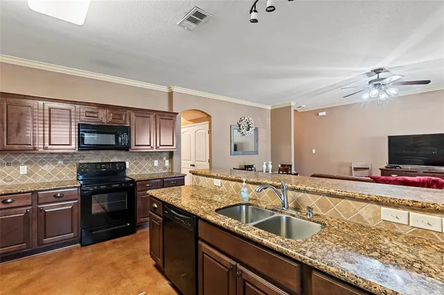 a kitchen with granite countertop a sink and appliances