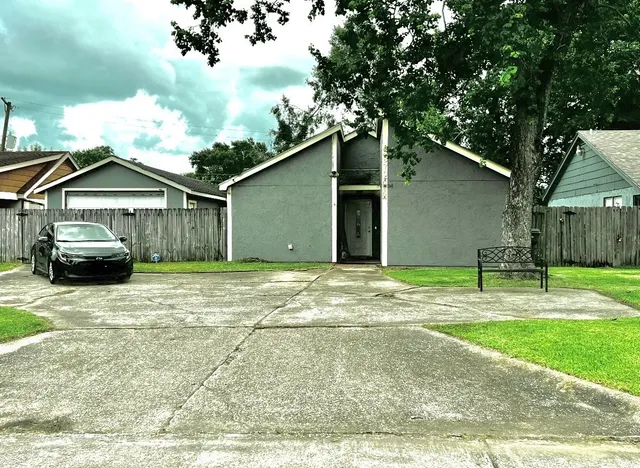 a yellow house with trees in front of it