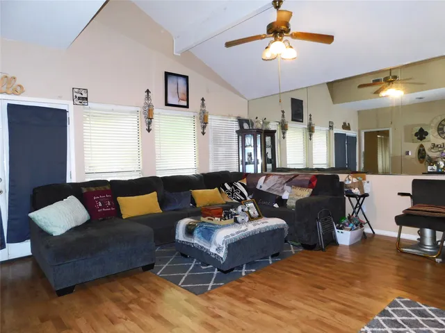 a living room with furniture and wooden floor