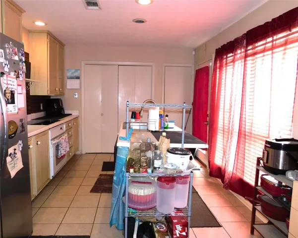 a dining room with furniture and a flat screen tv