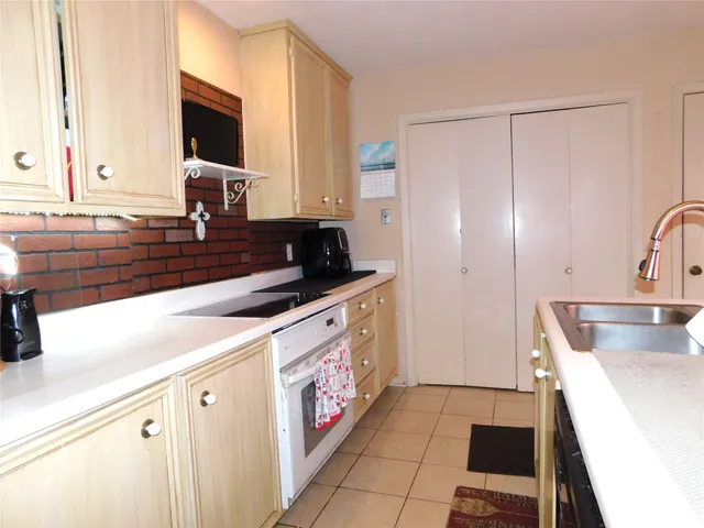 a kitchen with a sink stove and refrigerator