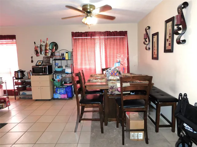 a dining room with furniture and window