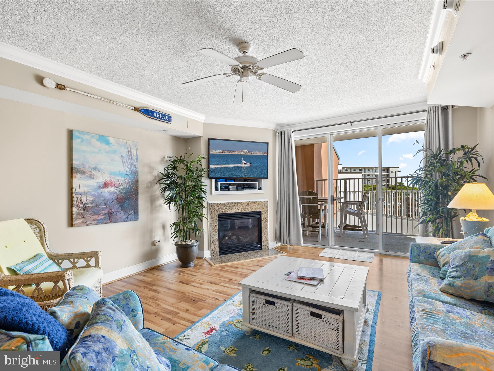 11900 Coastal Highway, Unit 102 Ocean City, MD 21842 - Photo 12 of 39 a bedroom with furniture and a fireplace