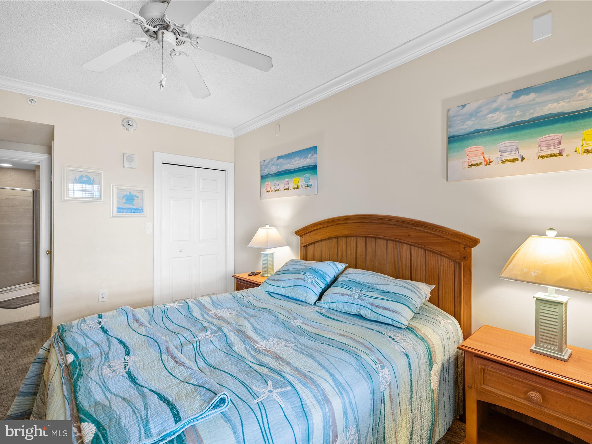 11900 Coastal Highway, Unit 102 Ocean City, MD 21842 - Photo 18 of 39 a bedroom with a bed and a lamp