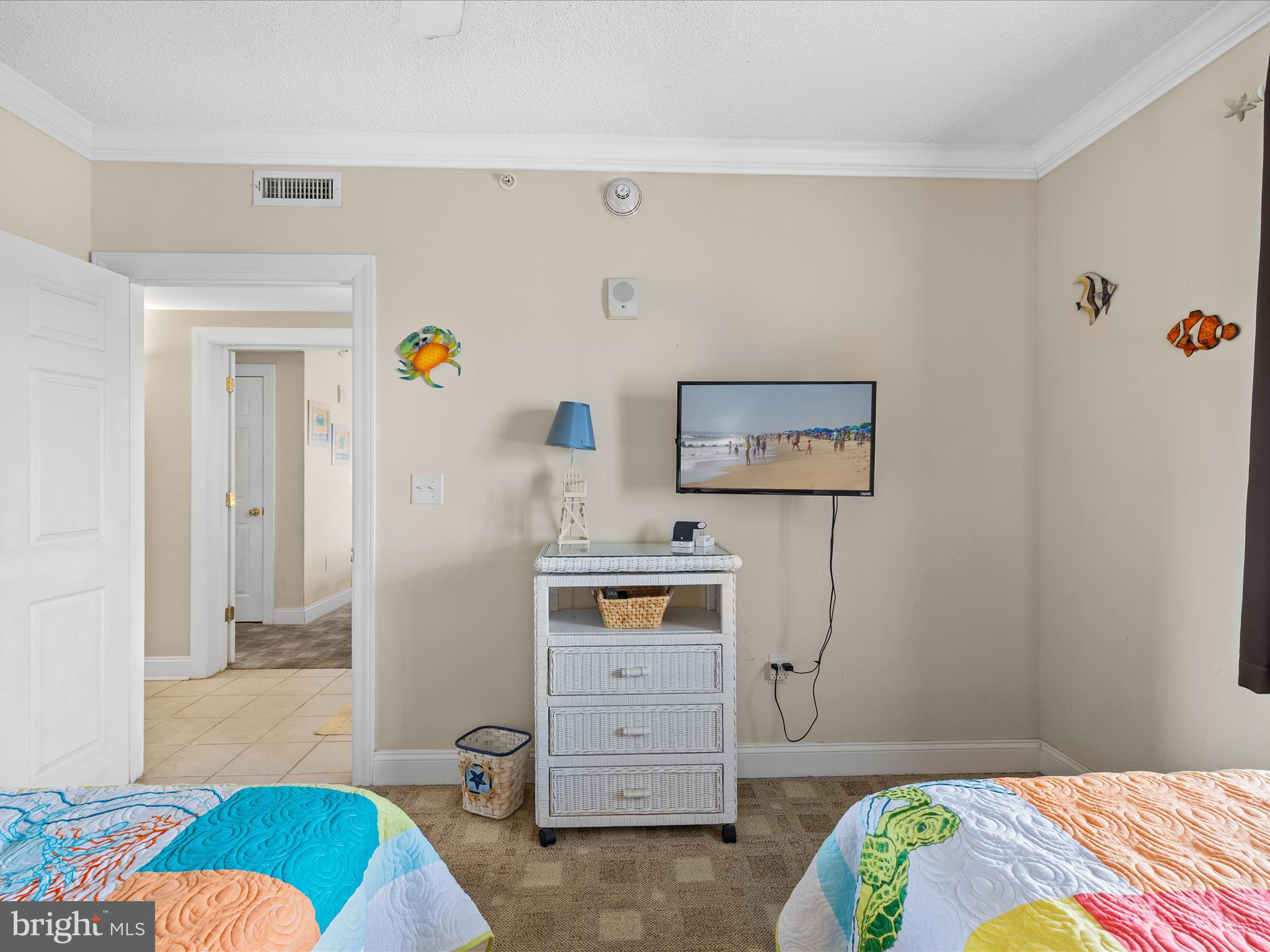 11900 Coastal Highway, Unit 102 Ocean City, MD 21842 - Photo 24 of 39 a bedroom with a bed and furniture